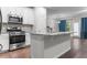 Bright kitchen featuring stainless steel appliances, granite countertops, and white cabinetry at 7168 Kingswood Run Dr, Atlanta, GA 30340