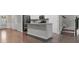 Open-concept kitchen features white cabinetry, granite countertops, stainless steel appliances, and a functional kitchen island at 7168 Kingswood Run Dr, Atlanta, GA 30340