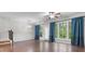 Spacious living room featuring hardwood floors, large windows, and elegant trim work at 7168 Kingswood Run Dr, Atlanta, GA 30340