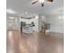 Open-concept living area with hardwood floors, a modern kitchen, and staircase access at 7168 Kingswood Run Dr, Atlanta, GA 30340