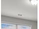 View of room with white walls and large window with light shining through at 7168 Kingswood Run Dr, Atlanta, GA 30340