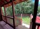 Cozy back yard featuring a wood fence and lush green space, viewed from a shaded porch at 1001 Park Gate Pl, Stone Mountain, GA 30083