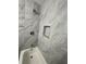 Updated bathroom with marble tile surround and built-in niche at 1001 Park Gate Pl, Stone Mountain, GA 30083