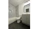 Updated bathroom with marble tile surround and gray vanity at 1001 Park Gate Pl, Stone Mountain, GA 30083