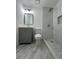 Bathroom featuring a gray vanity, modern fixtures, and a shower with stylish tile at 1001 Park Gate Pl, Stone Mountain, GA 30083