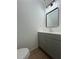 Modern bathroom features a gray vanity, updated faucet and a contemporary mirror at 1001 Park Gate Pl, Stone Mountain, GA 30083
