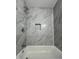 Updated bathroom with marble tile surround and built-in niche at 1001 Park Gate Pl, Stone Mountain, GA 30083