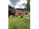 Traditional brick home with a well-manicured front lawn and blue shutters and front door at 1001 Park Gate Pl, Stone Mountain, GA 30083