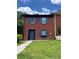 Traditional brick townhouse featuring blue shutters and well-maintained landscaping at 1001 Park Gate Pl, Stone Mountain, GA 30083