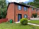 View of the brick facade townhome featuring blue shutters and a well-maintained lawn at 1001 Park Gate Pl, Stone Mountain, GA 30083