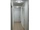 Bright hallway with neutral tile flooring and access to multiple rooms, illuminated by modern ceiling lights at 1001 Park Gate Pl, Stone Mountain, GA 30083