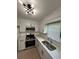 Spacious kitchen with stainless steel appliances, white cabinets and modern light fixture at 1001 Park Gate Pl, Stone Mountain, GA 30083
