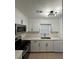 Bright kitchen with stainless steel appliances, white cabinetry, and quartz countertops at 1001 Park Gate Pl, Stone Mountain, GA 30083