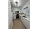 Well-lit kitchen boasts stainless steel appliances, white cabinets and quartz countertops at 1001 Park Gate Pl, Stone Mountain, GA 30083