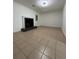 Living room featuring tile flooring, a fireplace with black brick surround, and a door to the exterior at 1001 Park Gate Pl, Stone Mountain, GA 30083