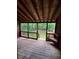 Covered back porch features wood flooring and a backyard view at 1001 Park Gate Pl, Stone Mountain, GA 30083