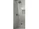 Close-up of a renovated shower with white and gray marble-style tile, niche, and modern fixtures at 1001 Park Gate Pl, Stone Mountain, GA 30083