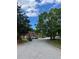 Street view featuring townhomes, ample parking and mature trees on a cloudy day at 1001 Park Gate Pl, Stone Mountain, GA 30083
