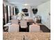 Dining room with large table, neutral upholstered chairs and fireplace view at 110 Halibut Cir, Covington, GA 30016
