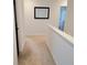 Bright hallway featuring neutral carpeting, white walls, and a simple mirror, enhancing the home's spacious feel at 110 Halibut Cir, Covington, GA 30016