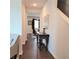 Bright hallway with dark hardwood floors, a decorative table, artwork, and a view to adjacent living areas at 110 Halibut Cir, Covington, GA 30016