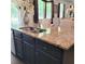 Granite island in a modern kitchen with stainless steel sink and plenty of counter space at 110 Halibut Cir, Covington, GA 30016