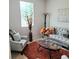 Cozy living room featuring a tufted couch, decorative pillows, a glass coffee table, and a stylish floor lamp at 110 Halibut Cir, Covington, GA 30016