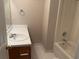 Simple bathroom featuring a shower-tub combo, single sink vanity, and tile flooring at 1177 Arlington Sw Ave, Atlanta, GA 30310