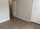 Clean bedroom with wood-look floors, closet, and access to another room at 1177 Arlington Sw Ave, Atlanta, GA 30310