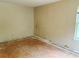 Bedroom showcasing the potential for renovation, featuring bare floors and plain walls at 1177 Arlington Sw Ave, Atlanta, GA 30310