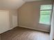 Bedroom with wood-look floors, window, and a closet for ample storage space at 1177 Arlington Sw Ave, Atlanta, GA 30310