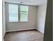 Bedroom featuring wood-look floors and bright natural light from two windows at 1177 Arlington Sw Ave, Atlanta, GA 30310