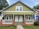 Charming home featuring a covered porch with classic architectural elements and a well-maintained lawn at 1177 Arlington Sw Ave, Atlanta, GA 30310