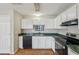 Functional kitchen with white cabinetry, stainless steel appliances, and wood flooring at 1177 Arlington Sw Ave, Atlanta, GA 30310