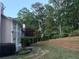 Well-maintained backyard features tiered retaining wall, landscaping, and mature trees at 1235 Legend Run, Alpharetta, GA 30005