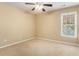 Tan bedroom featuring a ceiling fan and window that provide natural light at 1235 Legend Run, Alpharetta, GA 30005
