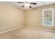 Bedroom featuring neutral walls and carpet with a ceiling fan and a window offering ample natural light at 1235 Legend Run, Alpharetta, GA 30005
