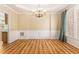 Formal dining room with wood floors, wainscoting, elegant chandelier, and natural light at 1235 Legend Run, Alpharetta, GA 30005