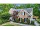 Stately brick home with lush landscaping and mature trees at 1235 Legend Run, Alpharetta, GA 30005