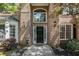 Charming front door entrance framed by brick and manicured landscaping at 1235 Legend Run, Alpharetta, GA 30005