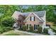 Charming two-story brick home with a manicured lawn and mature trees, offering classic curb appeal at 1235 Legend Run, Alpharetta, GA 30005