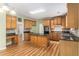 Open kitchen with wooden cabinets, island, and granite countertops at 1235 Legend Run, Alpharetta, GA 30005