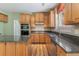 Bright kitchen featuring wood cabinets, granite countertops, and stainless appliances at 1235 Legend Run, Alpharetta, GA 30005