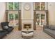 Living room with fireplace, two-story windows, and modern decor at 1235 Legend Run, Alpharetta, GA 30005