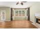 Bright living room with wood flooring, large windows, and a cozy fireplace at 1235 Legend Run, Alpharetta, GA 30005