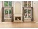 Living room with fireplace, two-story windows, and tile flooring at 1235 Legend Run, Alpharetta, GA 30005