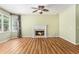 Inviting living room with hardwood floors, a fireplace, and natural light at 1235 Legend Run, Alpharetta, GA 30005
