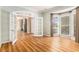 Open living space featuring a bay window, French doors, hardwood floors, and neutral wall color at 1235 Legend Run, Alpharetta, GA 30005