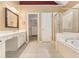 Main bathroom featuring double sinks, walk-in closet, tiled floor, and a separate shower and tub at 1235 Legend Run, Alpharetta, GA 30005