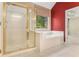 Main bathroom with a glass-enclosed shower and a separate soaking tub beneath a window at 1235 Legend Run, Alpharetta, GA 30005